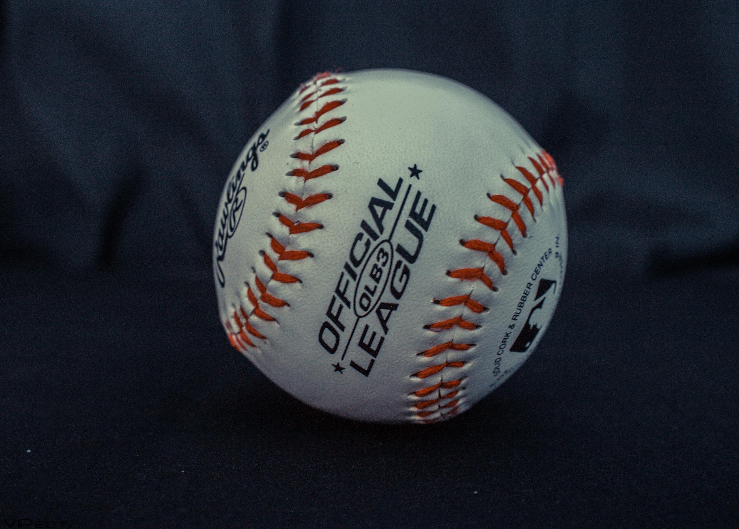 Detailed close-up of an official league baseball with visible branding and stitches.